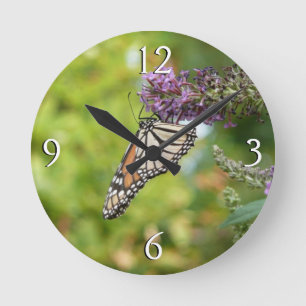 Horloge Ronde Papillon Monarque sur papillon pourpre Bush
