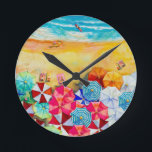 Horloge Ronde Parapluies<br><div class="desc">Vagues sur une plage de sable, bains de soleil sous des parasols colorés, cette horloge est un ajout amusant à votre maison de plage ou décor d'été ou offrir en cadeau. CORRESPONDRE des articles dans notre magasin.</div>