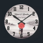 Horloge Ronde Red umbrella Love couple rustic romantic Wedding<br><div class="desc">Red umbrella watercolour painting. Les deux. Beautifully hand painted artwork by myself. Parfait pour Newlyweds. Le venin de Wedding anniversary. Valentine's Day present. You can customize it with your names and date.</div>