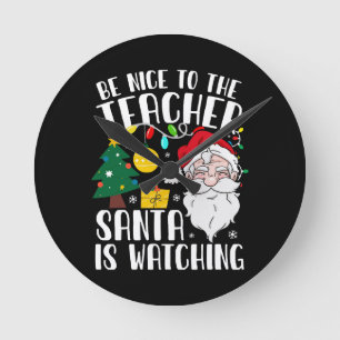 Horloge Ronde Sois gentil avec le professeur, le Père Noël regar