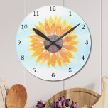 Horloge Ronde Tournesol aquarelle<br><div class="desc">Cette horloge à fleurs est décorée d'un tournesol jaune aquarelle et d'un arrière - plan bleu ciel. Fait un cadeau parfait pour réchauffer la maison. Aquarelle originale © Michele Davies.</div>