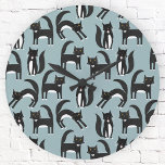 Horloge Ronde Tuxedo Black and White Cats<br><div class="desc">Cute black and white tuxedo cats going about their business. A fun pattern on a mid blue background.</div>