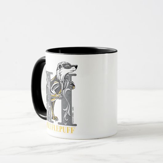 HUFFLEPUFF™ Gebroken embleem Mok (Voorkant links)