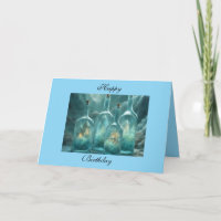 Huisjes in aquamarijnblauwe glazen flessen Happy B
