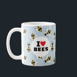 I Love Bees Patterned Sky Blue Coffee Mug<br><div class="desc">Pour l'apiariste en herbe,  fervent jardinier ou entomologiste de voisinage,  cette tasse montre une passion pour les pollinisateurs avec le texte classique "I Heart Bees" sur un cercle blanc sur un motif d'abeilles illustrées et à l'air amical sur un arrière - plan bleu ciel doux.</div>