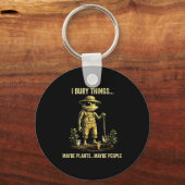Ik begraaf dingen misschien planten misschien mens sleutelhanger (Voorkant)