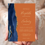 Invitation Marine Blue Gold Agate Brûlé Orange Mariage<br><div class="desc">Le bord gauche de cette élégante faire-part de mariage moderne est orné d'une bordure en aquarelle bleu marine ornée d'une parties scintillant en faux or. Le texte personnalisable combine écriture manuscrite couleur or, cuivre et polices italiques sur un arrière - plan orange brûlé. L'envers est assorti d'un design d'agate bleu...</div>