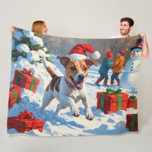 Jack Russell loopt in de sneeuw met kerstmuts Fleece Deken