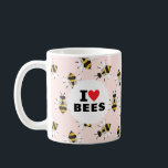 J'Aime Les Abeilles Motivées Pale Rose Café Mug<br><div class="desc">Pour l'apiariste en herbe, fervent jardinier ou entomologiste de voisinage, cette tasse montre une passion pour les pollinisateurs avec le texte classique "I Heart Bees" sur un cercle blanc sur un motif d'abeilles illustrées et à l'air amical sur un arrière - plan rose pâle doux.</div>