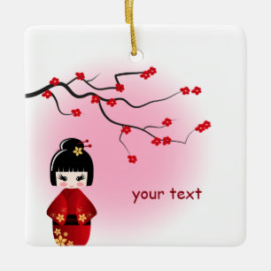 Japanse kokeshi-pop bij sakura-bloesemmeisjes keramisch ornament