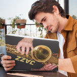 Jazzman Jouer Gold Saxophone Photo<br><div class="desc">Pour les amateurs de jazz ! Ce planificateur mensuel/hebdomadaire de calendrier garde toutes vos activités et horaires à venir organisées en un seul endroit pratique et présente l'image d'un jazzman jouant sa corne de saxophone ténor, de couleur or usée, avec le mot "JAZZ" imprimé en lettres de blocs de couleur...</div>