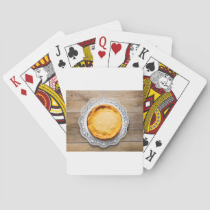 Jeu De Cartes Cheesecake on rustic wood cake top.