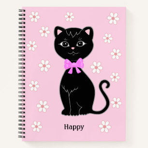 Joli chat noir et fleurs sur un cahier rose clair