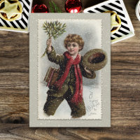 jongen in sneeuw met prettige kerstcadeautjes