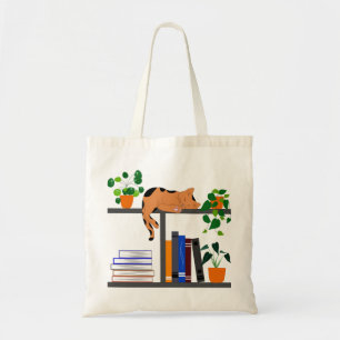 Kat dat op een boekenplank ligt, een kat boek en e tote bag