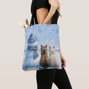 Katten die zitten met een sneeuwman in een veld draagtas