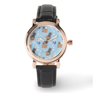 Katten in doos en melkdruppels op blauw horloge