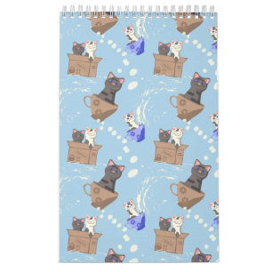 Katten in doos en melkdruppels op blauw kalender