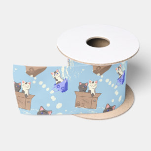 Katten in doos en melkdruppels op blauw lint