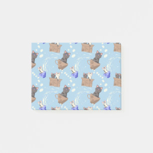 Katten in doos en melkdruppels op blauw post-it® notes