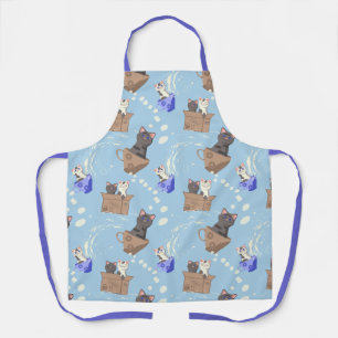 Katten in doos en melkdruppels op blauw schort