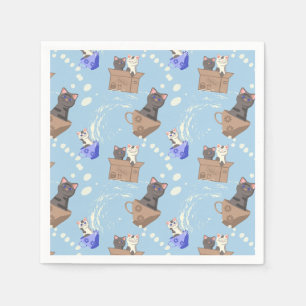 Katten in doos en melkdruppels op blauw servet