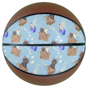Katten in doos en melkdruppels op blauwe ondergron basketbal