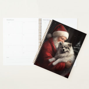 Keeshond avec le Père Noël Festif de Noël