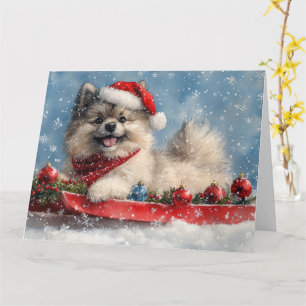 Keeshond-hond in slee Laat het sneeuwen Kerstmis Kaart