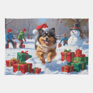 Keeshond-hond rent in de sneeuw met kerstmuts theedoek