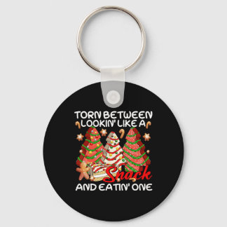 Kerstboom verscheurd tussen eruit zien als een sna sleutelhanger