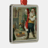 kerstman zet zijn pak aan metalen ornament (Rechts)