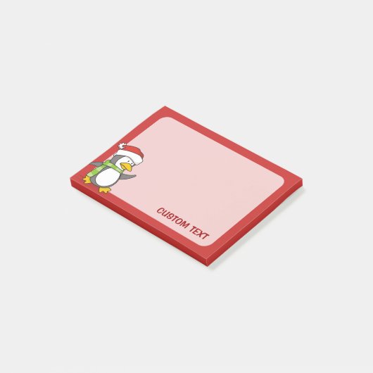 Kerstpinguïn loopt op sneeuw post-it® notes (Schuin)