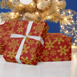 Kerstsneeuwvlokken van goud op een rode achtergron cadeaupapier