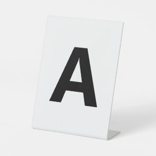 Kies een willekeurige letter   Lettertype: openen  Reclamebord Met Voetstuk