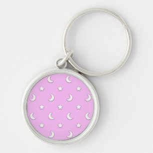 Kleine witte sterren en manen op roze sleutelhanger