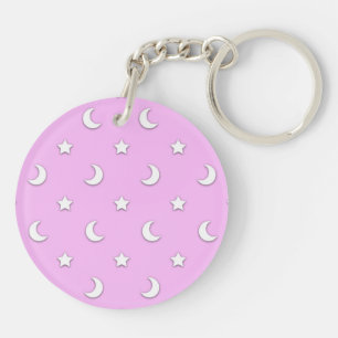 Kleine witte sterren en manen op roze sleutelhanger