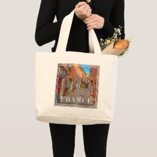 Kleurrijk Frans dorp op de heuvel Grote Tote Bag