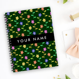 Kleurrijke bloemen, groene achtergrond, zwart notitieboek