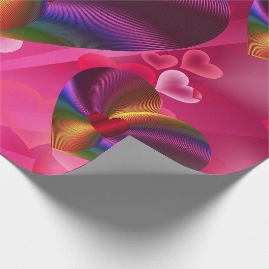 Kleurrijke harten in hartroze cadeaupapier (Hoek)