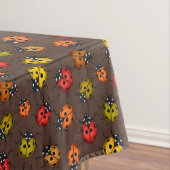 Kleurrijke ladybugs op bruin tafelkleed (Voorbeeld)