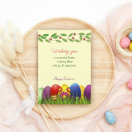 Kleurrijke paaseieren met een grasvakantieeieren bedankkaart
