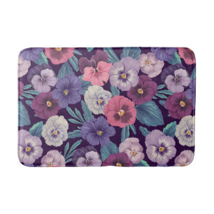 Kleurrijke pansies op diep violet badmat