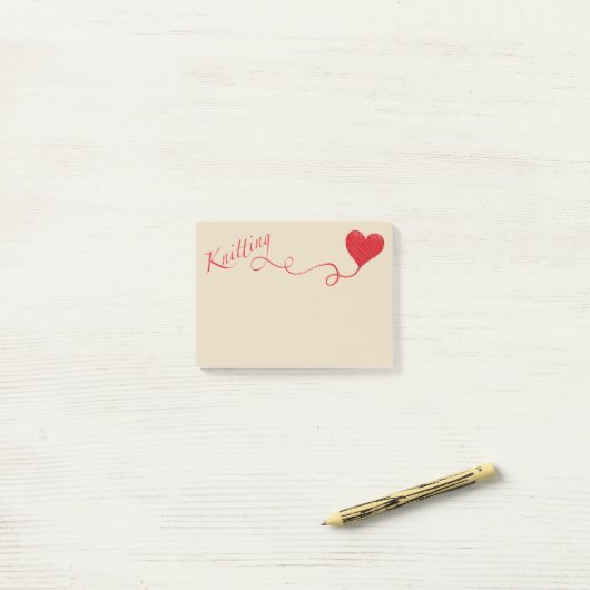 Knitting met hartritme in het rood post-it® notes (Op bureau)