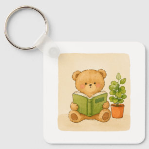 Knuffelige teddybeer leest boek sleutelhanger
