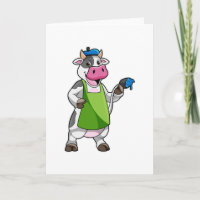 Koe als schilder met verf en schort