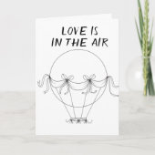 **L'AMOUR** EST EN L'AIR **SUR NOTRE CARTE ANNIVER (Devant)