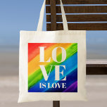L'amour est la fierté de l'amour<br><div class="desc">Ce Sac fourre-tout Pride est décoré avec LOVE IS LOVE en caractères blancs gras sur un arc-en-ciel d'aquarelle arrière - plan de rouge, orange, jaune, vert, bleu et violet. Aquarelle originale © Michele Davies.</div>