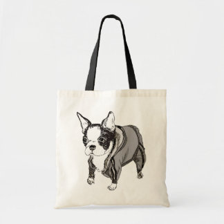 Le chiot de Boston Terrier sue dedans le sac de