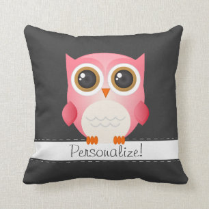 Le hibou rose sur le coussin gris-foncé, le